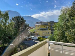 a balcony with a view of a building and a parking lot at Apartment Manuela in Merano +4 photos