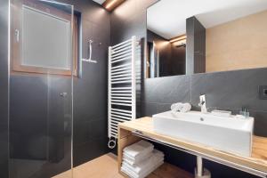 a bathroom with a sink and a shower at Villa Kriendl Nr 4 Dreifinger in Valdaora +21 photos