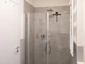 a shower with a glass door in a bathroom at Apartment Manuela in Merano