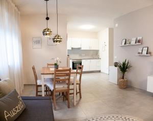 a dining room and kitchen with a table and chairs at Apartment Manuela in Merano