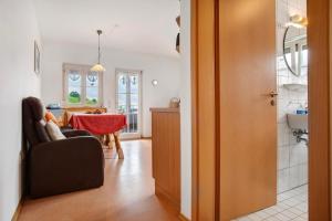 a kitchen and a living room with a table at Haus Hilebrand in Kressbronn am Bodensee +108 photos