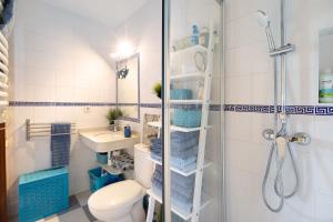a bathroom with a shower and a toilet and a sink at Apartamento La Barca - Chipiona in Chipiona +17 photos