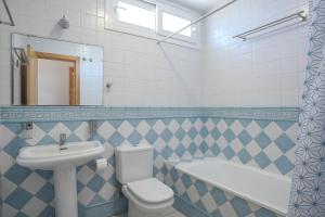 a bathroom with a sink and a toilet and a tub at Michalete Fernando - Sólo Familias in Conil de la Frontera +16 photos