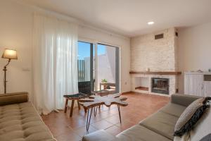 a living room with a couch and a fireplace at Michalete Fernando - Sólo Familias in Conil de la Frontera