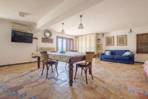 a living room with a table and chairs at Casa della Poiana in Lipari