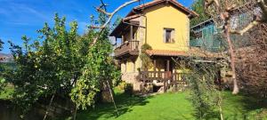a large yellow house with trees in front of it at Los Avellanos Casa 3 in Celis