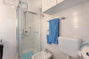 a bathroom with a shower and a toilet and a sink at Casa Lago Leo in Omegna +26 photos