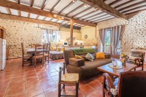 a living room with a couch and a table at Gites les Renardiers in Peyraube