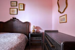 a bedroom with a bed and a table with a lamp at Les Cigales in Cassis