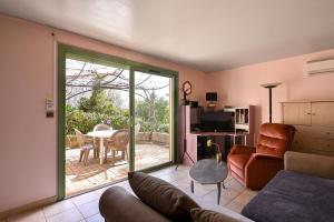 a living room with a couch and a sliding glass door at Les Cigales in Cassis