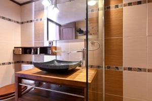 a bathroom with a stone sink on a wooden counter at Les Cigales in Cassis