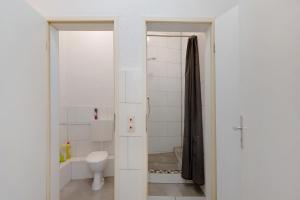 a white bathroom with a toilet and a shower at an der Mosel in Kaisersesch +11 photos