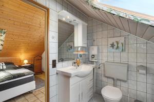 a bathroom with a sink and a toilet and a bed at Stoffel in Darstein +18 photos