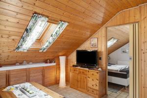 a living room with a tv in a wooden cabin at Stoffel in Darstein