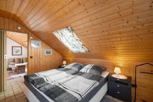 a bedroom with a bed in a wooden room at Stoffel in Darstein
