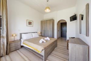 a bedroom with a bed with two towels on it at Alexandra Studio 10 in Lefkimmi
