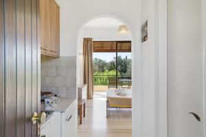 a kitchen with an open door leading to a bedroom at Alexandra Studio 10 in Lefkimmi