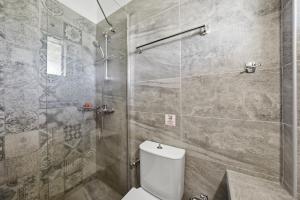a bathroom with a toilet and a glass shower at Alexandra Studio 10 in Lefkimmi