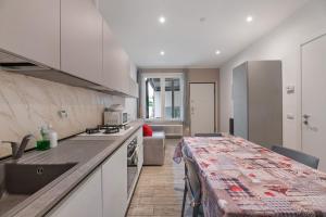 a kitchen with a counter and a table in a room at La Casa Di Angio - Val D'Intelvi in Lanzo dʼIntelvi