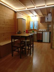 a kitchen with a table and chairs in a room at Le sorgenti - Chalet 42 in Palazzuolo sul Senio +9 photos
