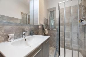 a bathroom with a white sink and a shower at La Casa Di Angio - Val D'Intelvi in Lanzo dʼIntelvi +7 photos