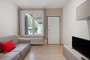 a living room with a couch and a flat screen tv at La Casa Di Angio - Val D'Intelvi in Lanzo dʼIntelvi
