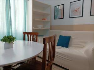 a living room with a table and a couch at Holiday sea 1 in Diano Marina