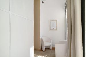 a white chair in a room with a window at Holiday sea 1 in Diano Marina +26 photos