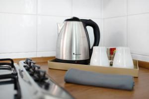 a tea kettle and two cups on a kitchen counter at Holiday sea 1 in Diano Marina