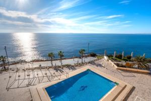 a swimming pool with a view of the ocean at 100 Beach Seaview in Torrevieja