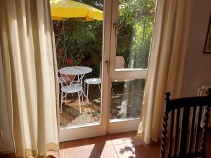 an open door to a patio with a table and chair at Ferienwohnung Cipolla in Oberkirch