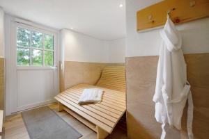 a room with a wooden bench and a window at Kraichgauer Haus in Oberreute +29 photos