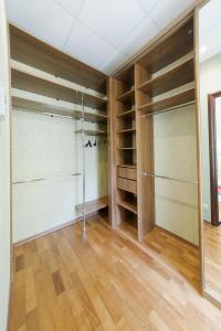 a walk in closet with glass doors and wooden floors at hth24 apartments on Mohovaya 4 in Saint Petersburg