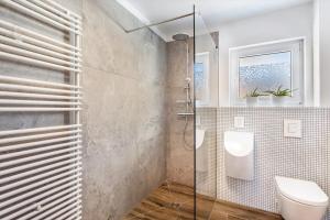 a bathroom with a glass shower and a toilet at Suiten im Alten Berghotel Antonia in Eslohe +22 photos