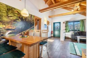 a living room with a large painting on the wall at Blockhaus - Ferienwohnung Sunrise in Erdmannsdorf