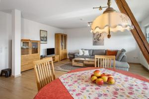 a living room with a table with fruit on it at Haus Hilebrand in Kressbronn am Bodensee