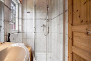 a bathroom with a shower and a sink at Lillis Ferienhaus Nr 27 in Göhren +13 photos