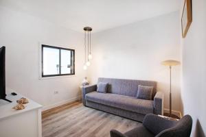 a living room with a couch and a tv at Eras Views in Las Eras