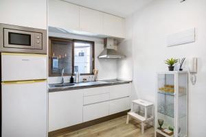 a white kitchen with a sink and a refrigerator at Eras Views in Las Eras