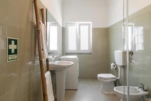 a bathroom with a toilet and a sink at Casa das Alfazemas in Cadaval +31 photos