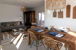 a living room with a wooden table and chairs at Casa das Alfazemas in Cadaval