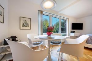 a white living room with a table and chairs at Landhaus Bleckede - App 1 Bleckede in Bleckede
