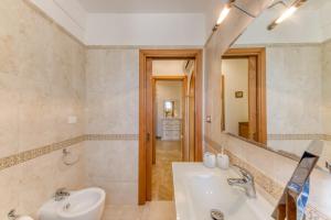 a bathroom with a sink and a mirror at Il Girasole in Torre Vado +32 photos
