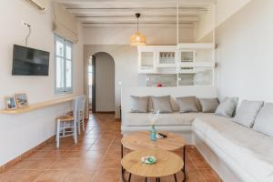 a living room with a white couch and a table at La Casa Tinos 22 in Tinos