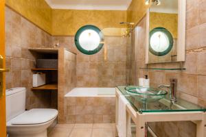 a bathroom with a toilet and a sink and a tub at Sa Mina in Santa Margalida +19 photos