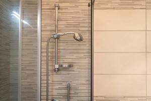 a shower with a shower head in a bathroom at Casa Macis vista mare in Isola Rossa