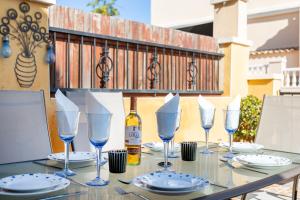 a table with glasses and a bottle of wine at Casa Susan in Torrevieja