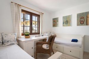 a bedroom with a desk and a bed and a window at Puerto Chico A in Playa Blanca +23 photos