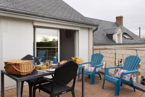 a patio with blue chairs and a table with food on it at Chambre D'hôtes Take-off - Chambre in Saint-Georges-sur-Cher