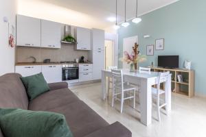 a kitchen and living room with a couch and a table at Dimora Biscari in Acate